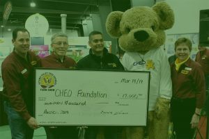 A group of people holding up a giant cheque.