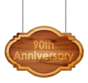 A wooden sign with the word 90th anniversary hanging on a chain.