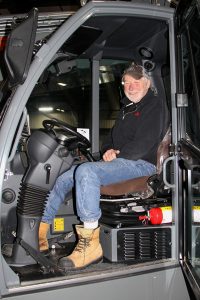 A man sitting in the driver's seat of a truck.