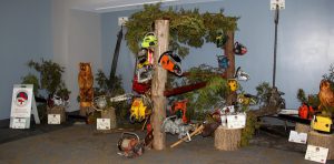 A display of chainsaws in a room.