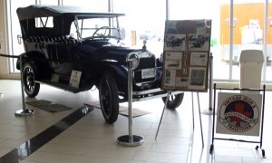 A vintage car on display in a museum.