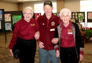 Three older people standing next to each other.