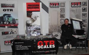 A man standing in front of a table with a gtr scale.