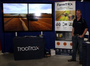 A man standing in front of a farm tx booth.