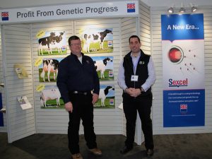 Two men standing in front of a display.