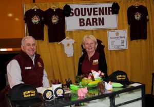 A man and woman standing in front of a booth.