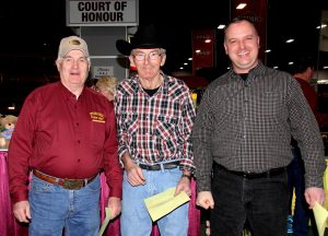 Three men standing next to each other.