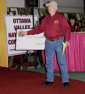 A man holding a check in front of a crowd.