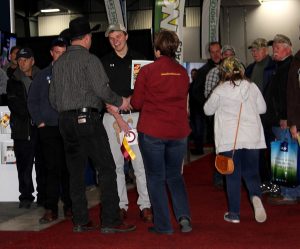 A group of people standing on a red carpet.