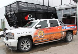 A truck is parked in front of a building.