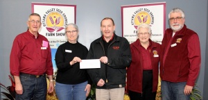 A man and two women holding a check.
