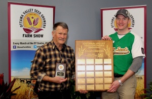 Two men holding a plaque and a trophy.