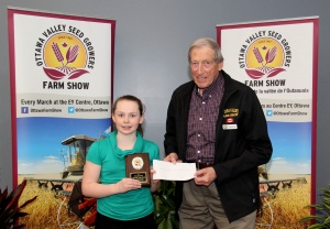 A girl and an older man holding a check.