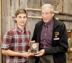 A man and boy holding a plaque