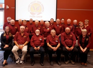 A group of men in red shirts and black hats.