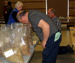 A man looking at bags of food on the table.