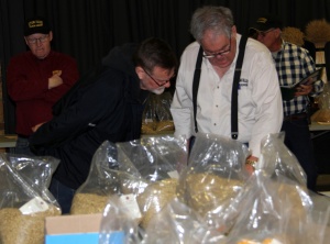 Two men looking at a bag of food.