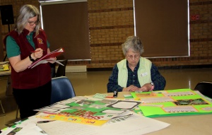 A woman sitting at a table with papers on it