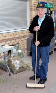 A man holding a stick in front of a table.