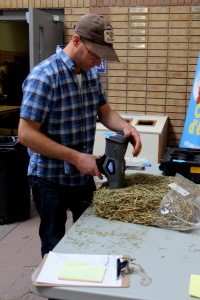 A man using an electric grass trimmer.