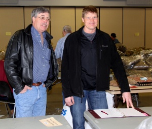 Two men standing next to each other in a room.