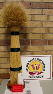 A straw hat and sign are on display.