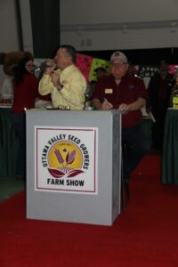 A man is speaking at the farm show.