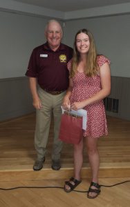 Man and woman smiling at award ceremony.