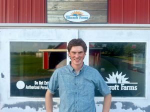 Man smiling in front of Tilecroft Farms building.